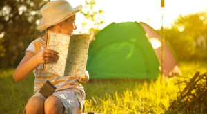 Boy camping holding a map